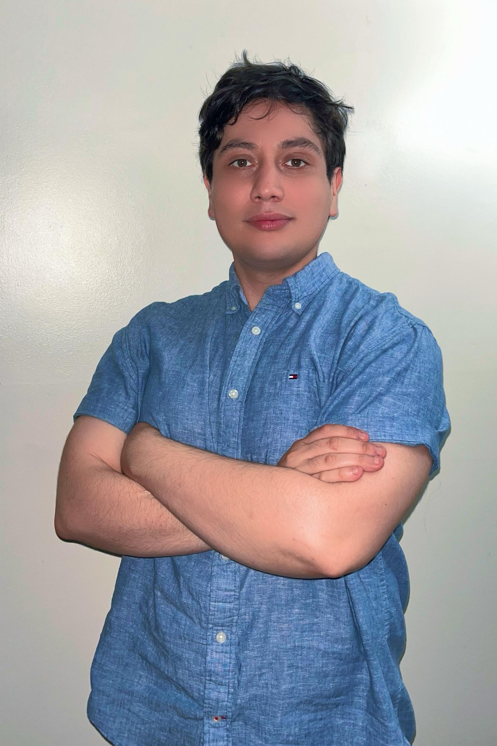 A man is kneeling down in front of a dump truck