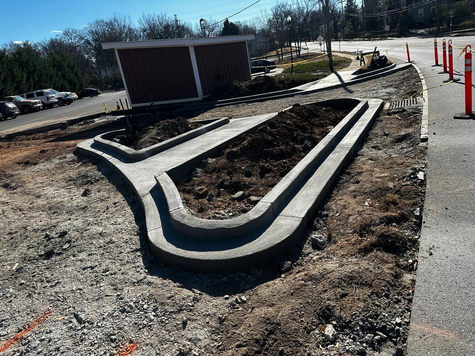 A concrete curb is being built on the side of a road