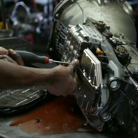 Mechanic Working On Car Transmission — Chicago, IL – AC Transmission