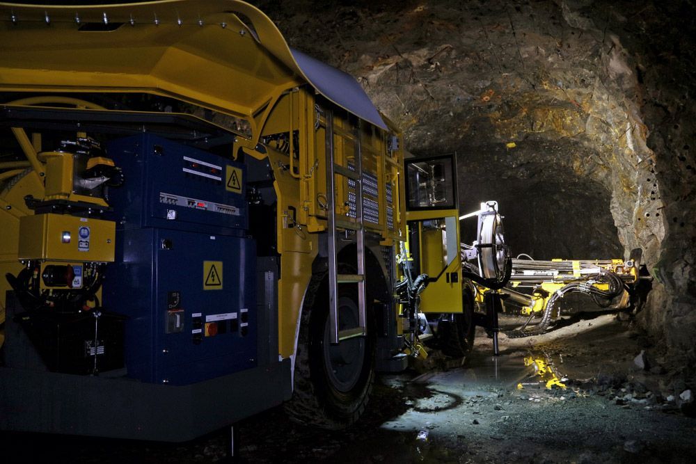 A Yellow And Blue Machine Is Sitting In A Dark Cave — Skilled Transport Training And Assessment in Woongarrah, NSW