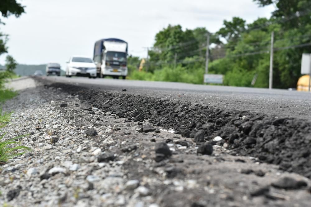 A Truck Is Driving Down A Road Next To A Gravel Road — Skilled Transport Training And Assessment in Woongarrah, NSW