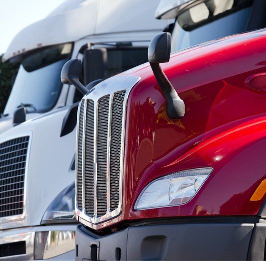 A Row Of Semi Trucks Are Parked Next To Each Other — Skilled Transport Training And Assessment in Woongarrah, NSW