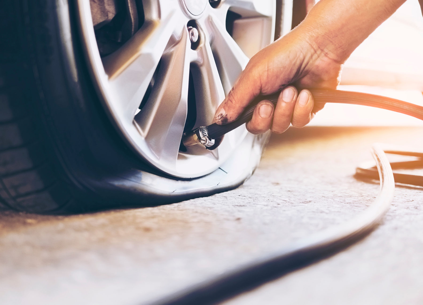 a person is pumping air into a car tire