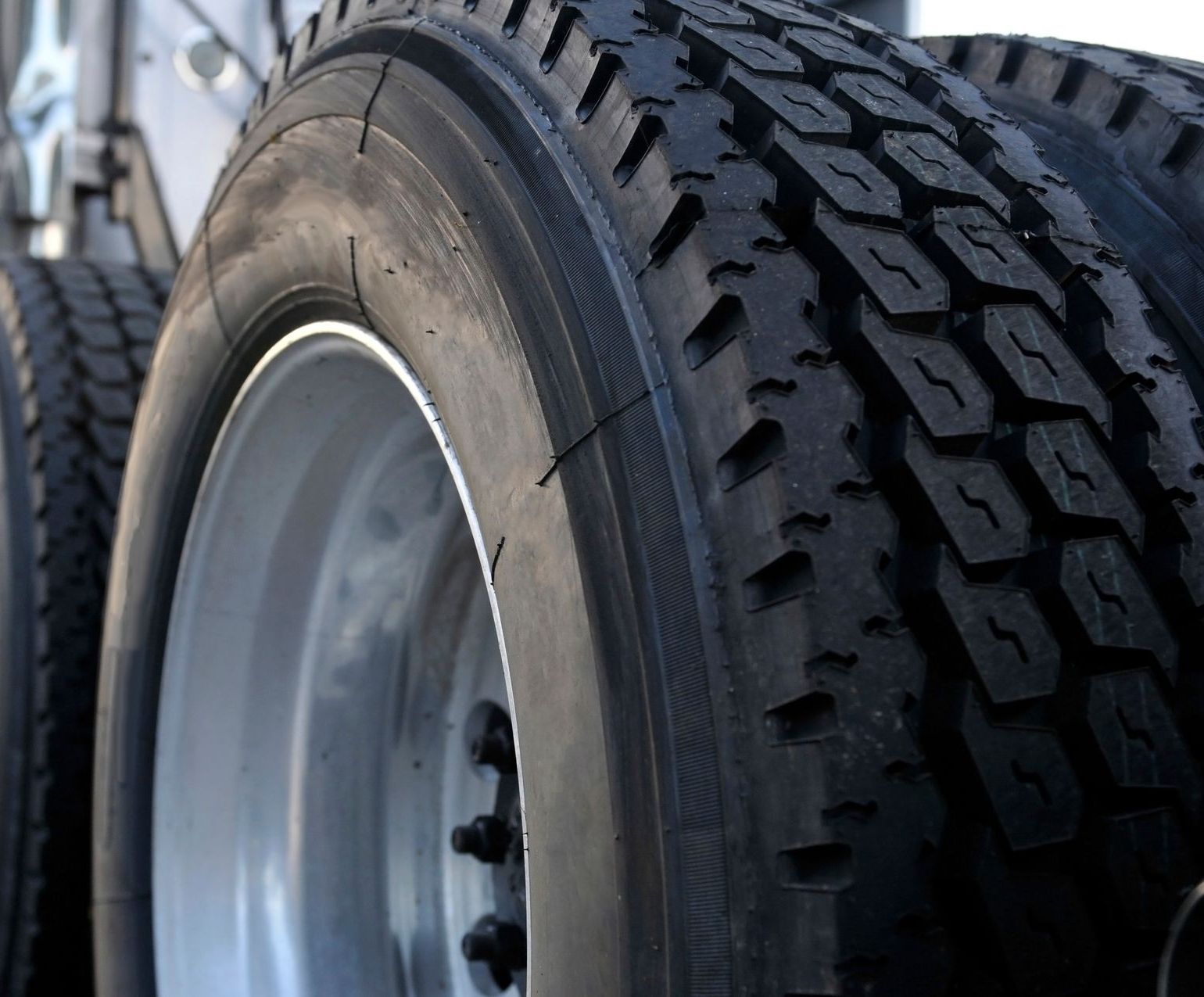 a row of tires are lined up on a shelf