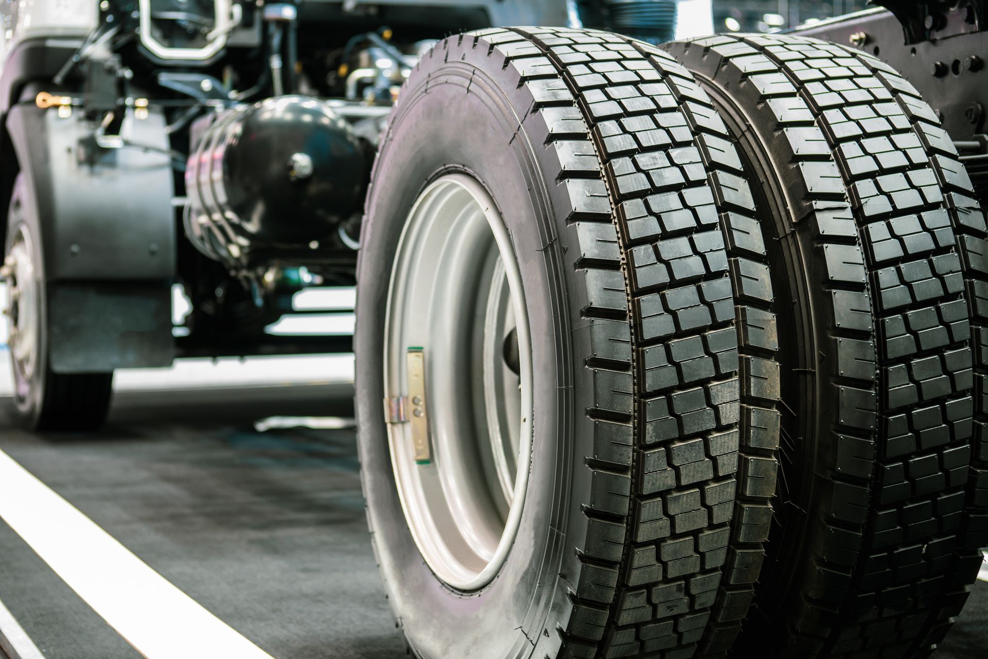 many tires are stacked on shelves in a store