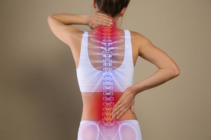 Person holding lower back and neck, with highlighted spine and pain areas on torso.