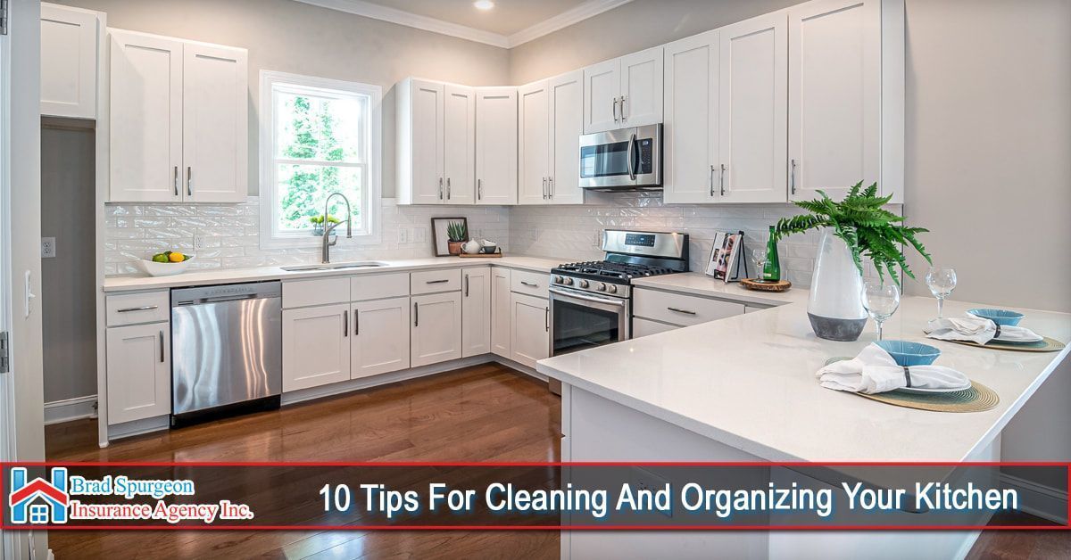 A bright, modern kitchen with white cabinets, stainless steel appliances, and a center island