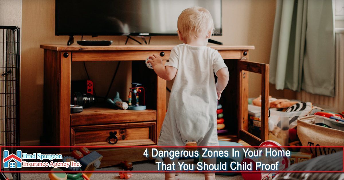 A toddler stands in a living room, reaching for an open wooden TV stand