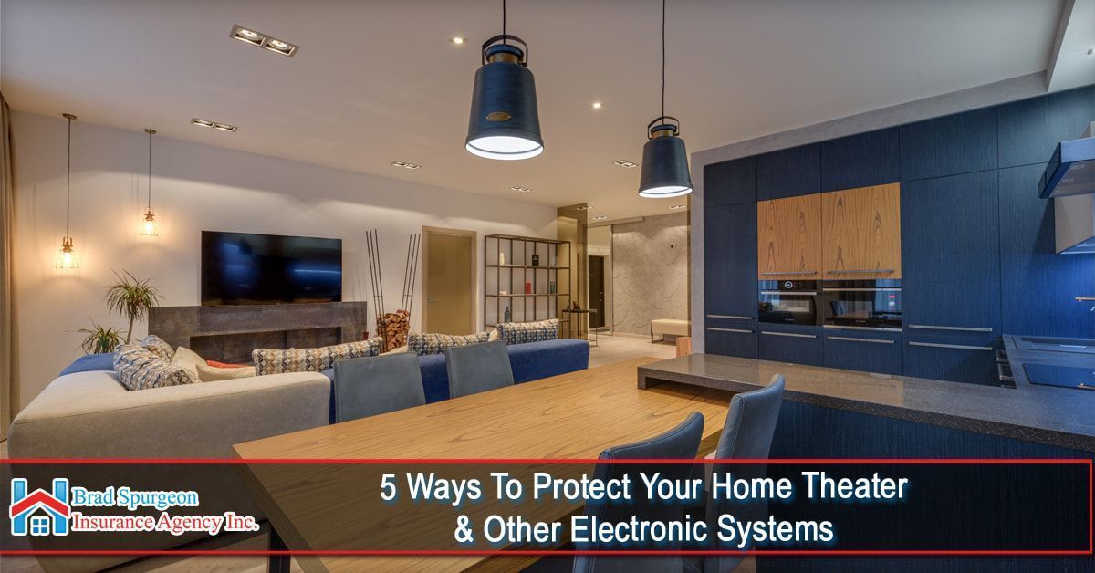 Modern open-plan living room with blue kitchen cabinets and a home theater area. 