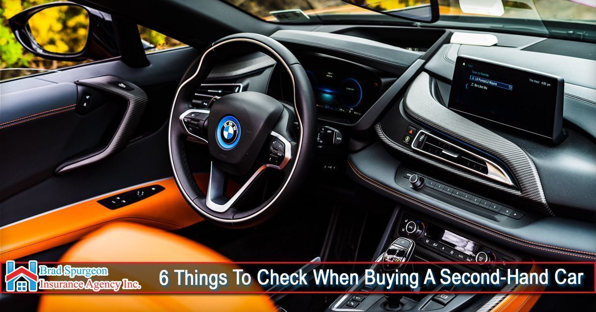 Interior of a luxury BMW car with orange seats and a dashboard
