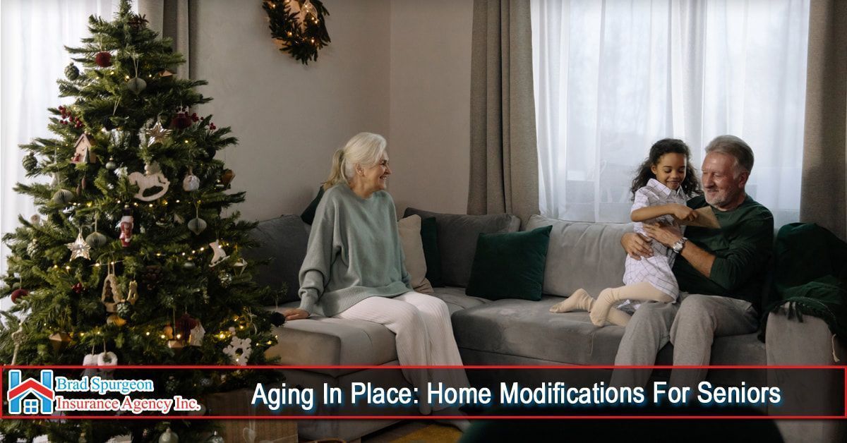 People sitting on a sofa in a living room with a Christmas tree.