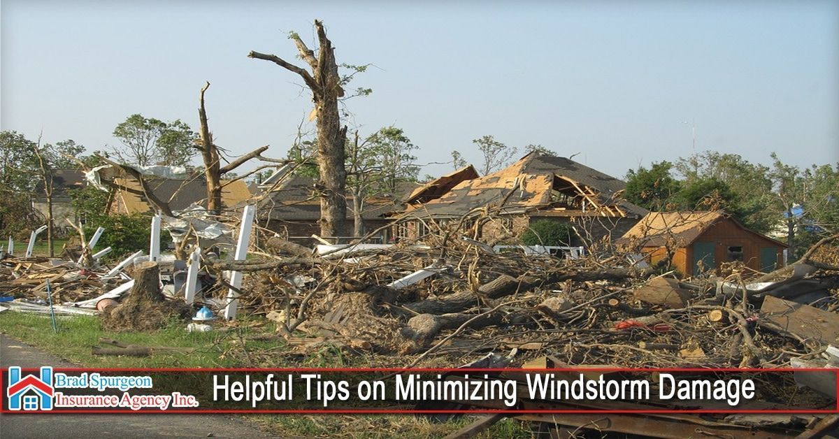 A scene of severe destruction after a windstorm, showing damaged houses and downed trees.