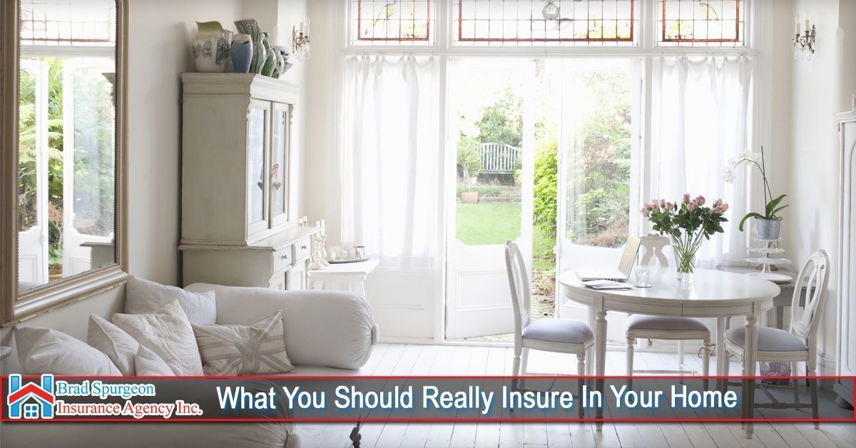 A bright, elegant dining and living room with white decor, a dining set, and a sofa. 