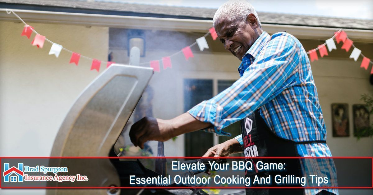 An adult grilling on a patio decorated with bunting