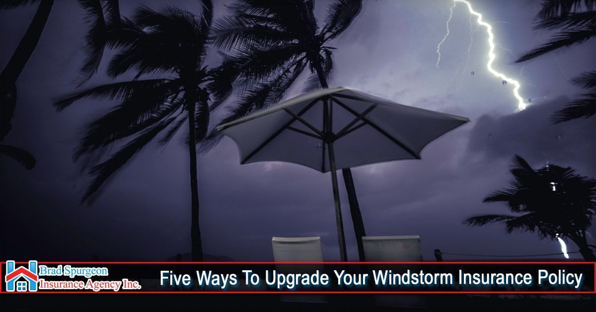 A lightning-filled stormy sky over a patio umbrella and chairs