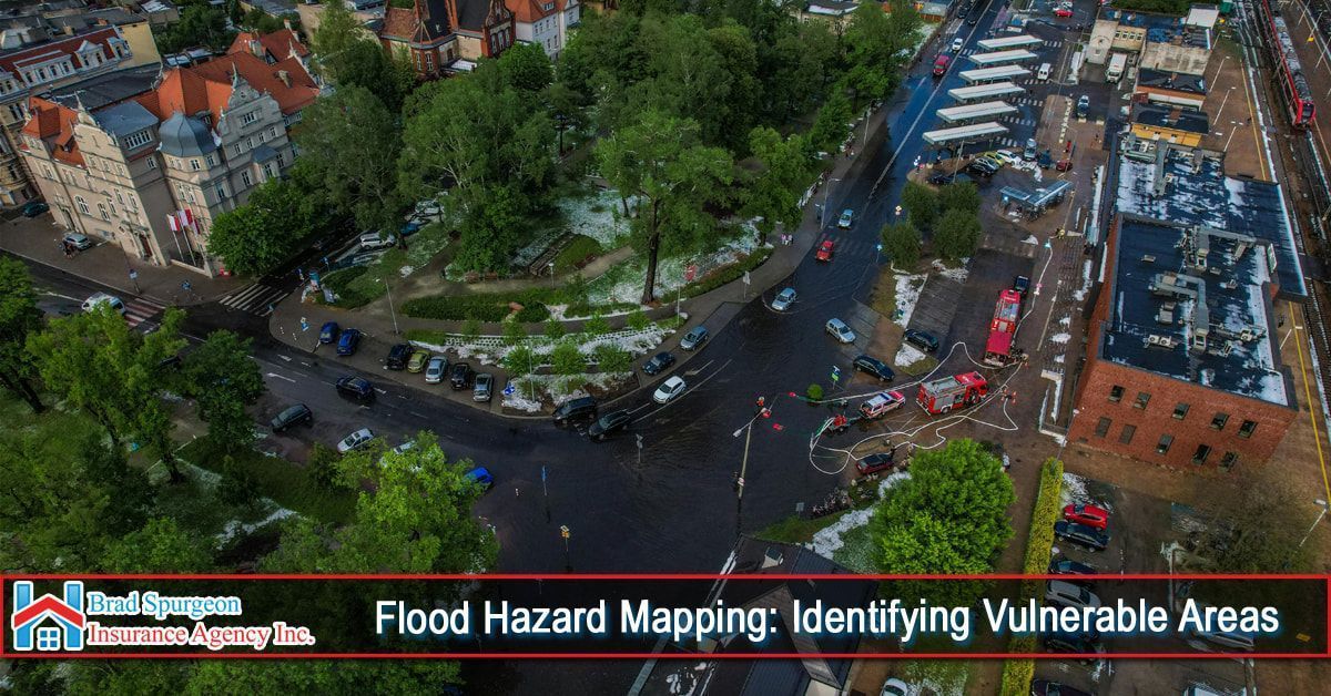 An aerial view of a wet city street lined with trees and buildings