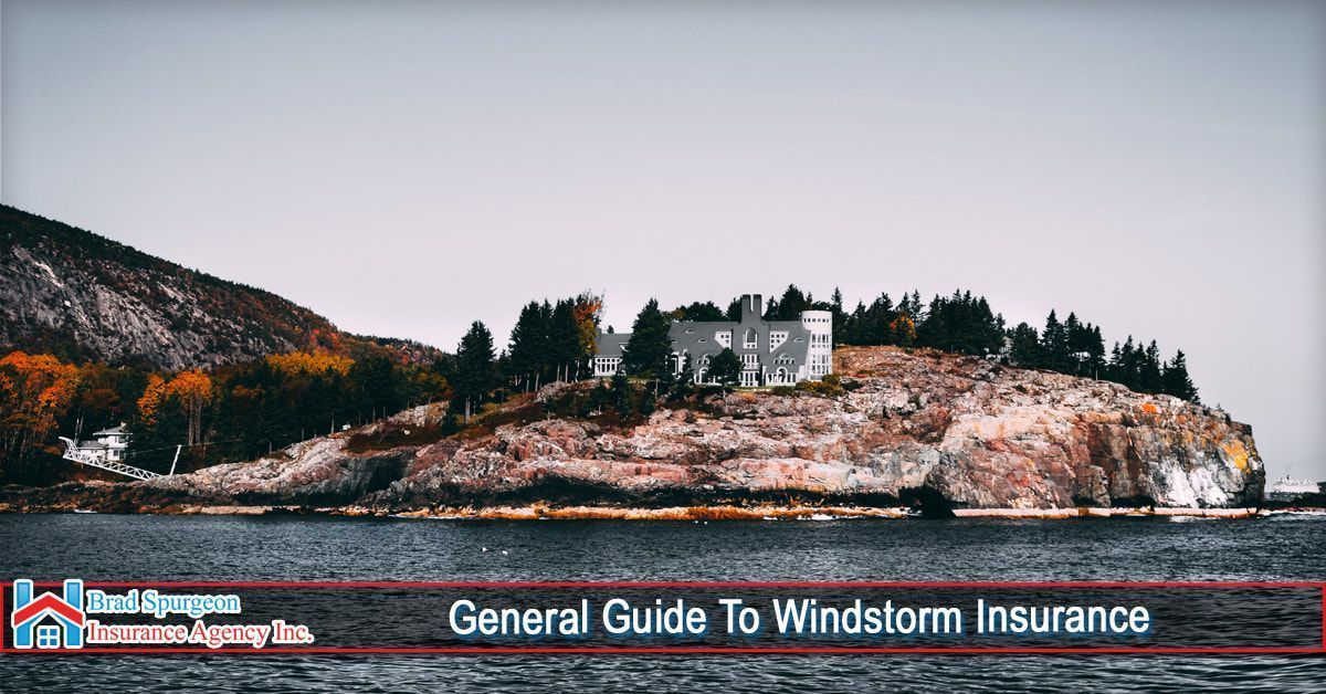A scenic coastal view of a rocky hill with trees and a house