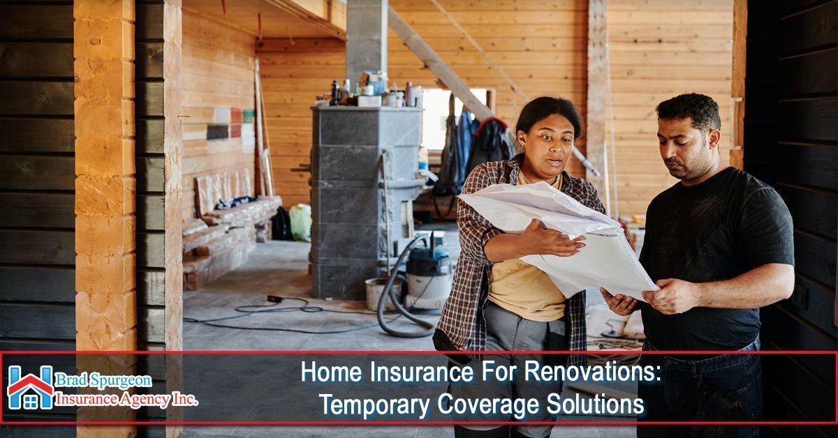 Two people reviewing blueprints in a home under construction