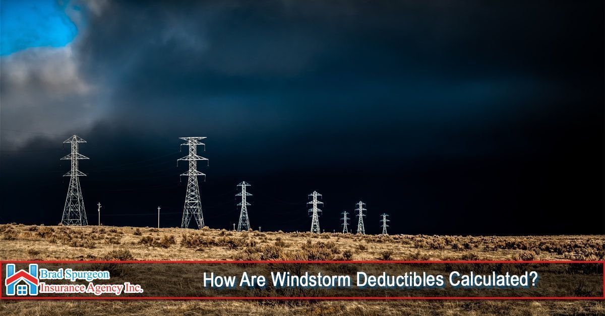 A row of electrical towers under a dark, stormy sky