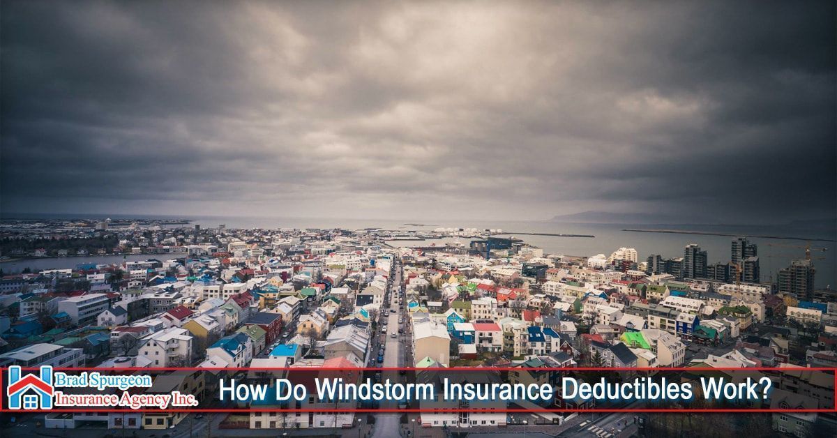 An aerial view of a coastal city under a dark, cloudy sky