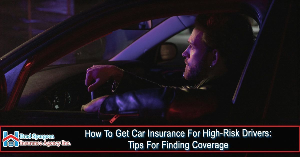 A driver sits in a car at night, illuminated by blue emergency lights