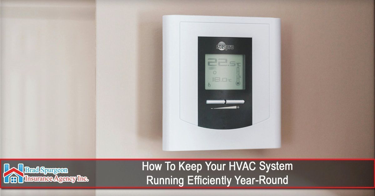 A white digital thermostat mounted on a tan wall