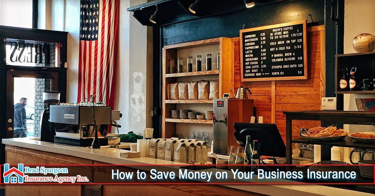 A view of a coffee shop counter with a chalkboard menu and an American flag