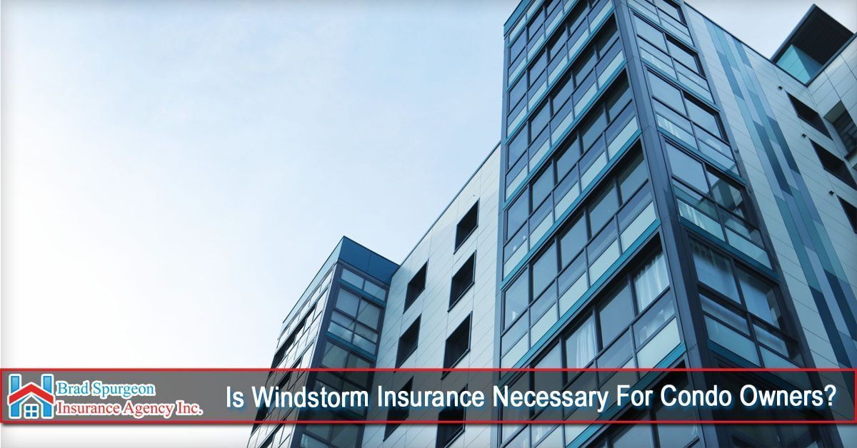 A modern glass-and-white apartment building against a pale sky 