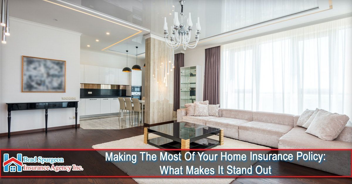 A modern, open-plan living room with a cream sofa, glass coffee table, and kitchen in the background.