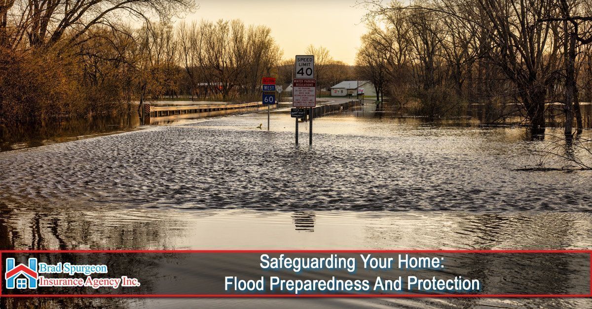 A flooded rural road with road signs partially submerged in water