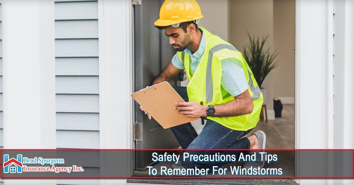 A worker in a yellow hard hat and vest inspects a doorway