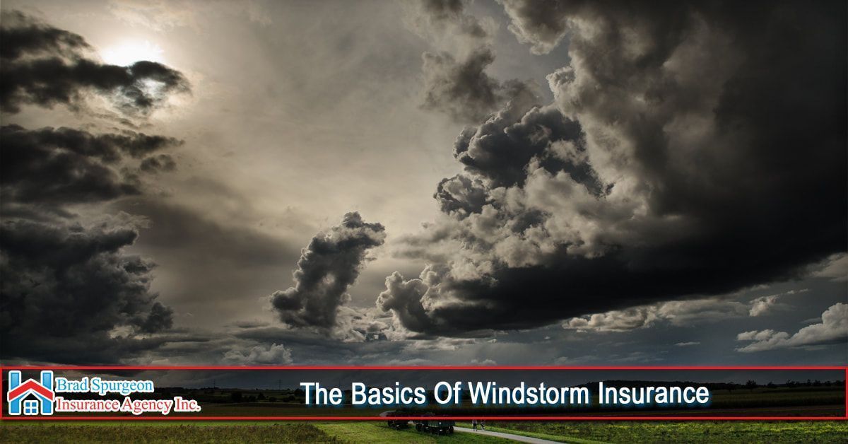 Dark, dramatic storm clouds fill the sky above a landscape