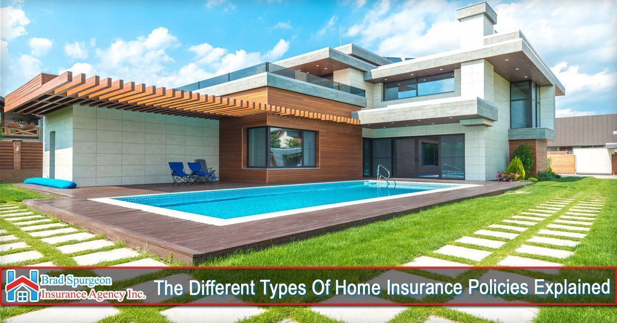 A modern multi-level house with a swimming pool and a green lawn under a sunny sky