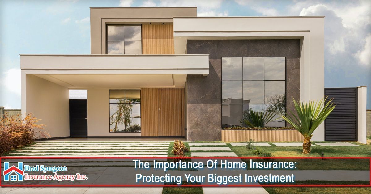 A modern house with a beige and gray exterior, featuring a carport and large windows