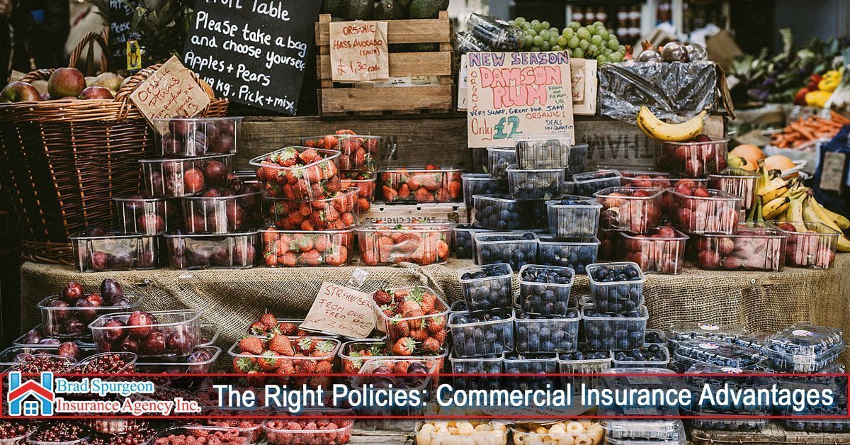A produce market stand with stacked boxes of strawberries and blueberries