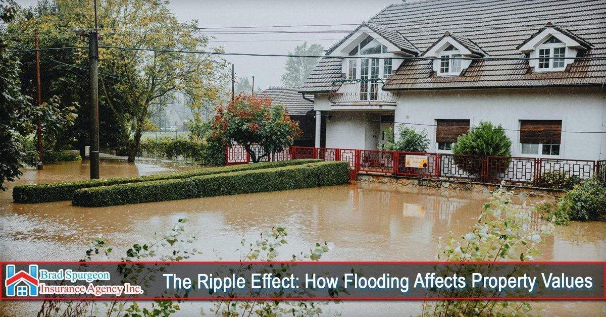 A two-story house surrounded by floodwaters