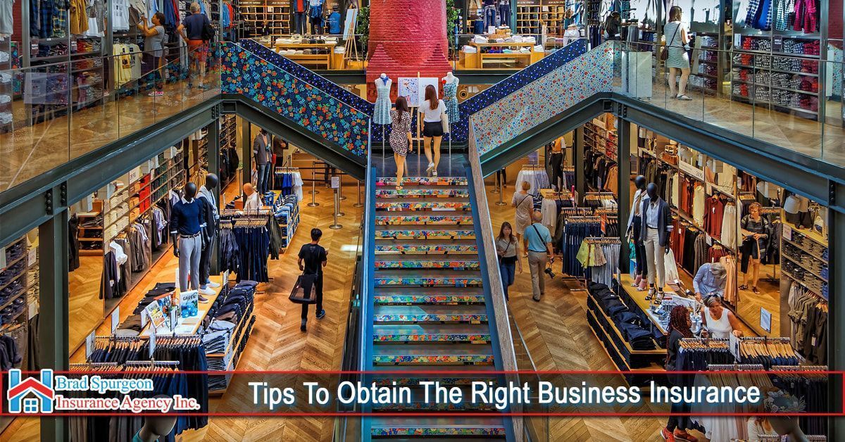 A multi-level retail clothing store with a central staircase 