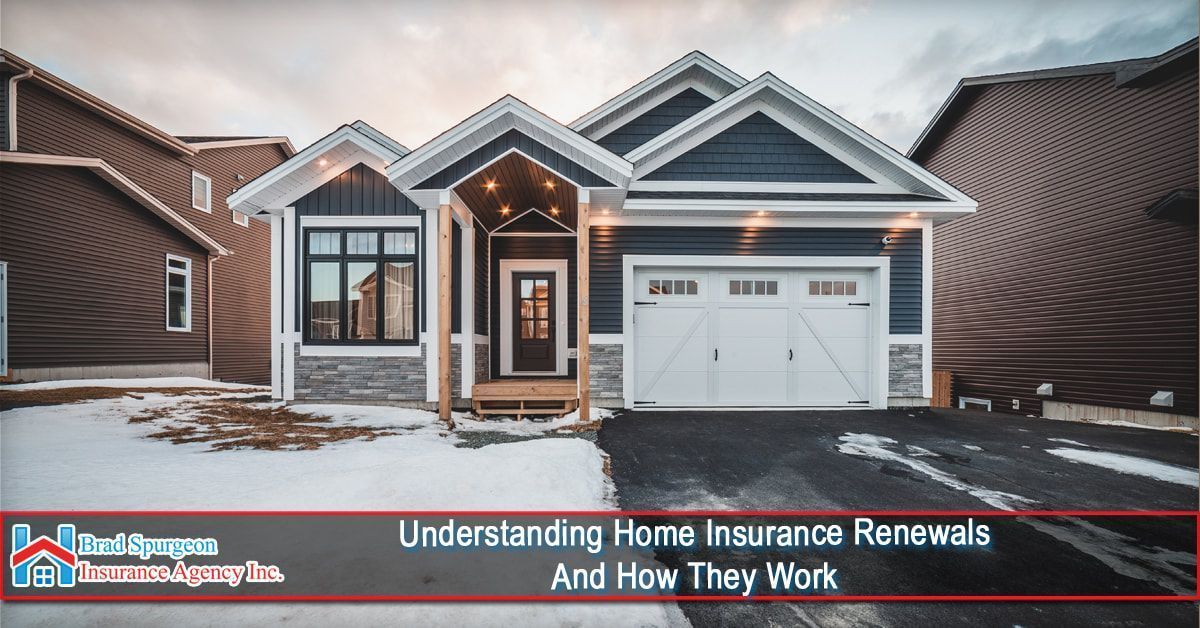 A modern blue-sided house with a white garage sits in a snowy yard