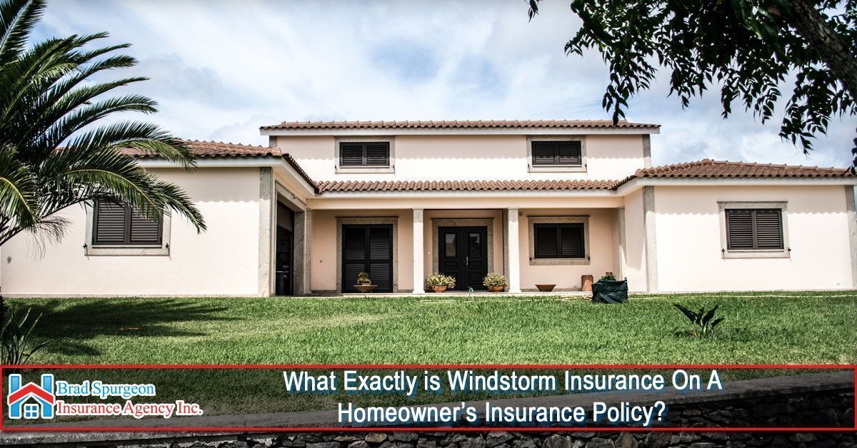 A single-story tan house with a tiled roof stands on a green lawn.