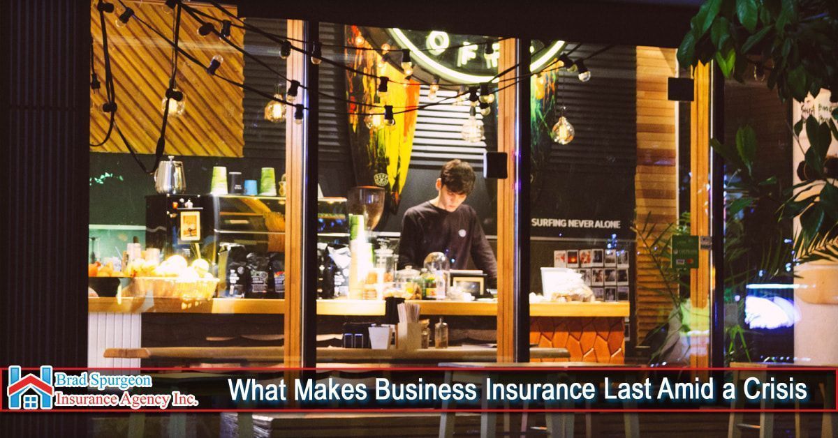A brightly lit cafe interior at night with a worker behind the counter
