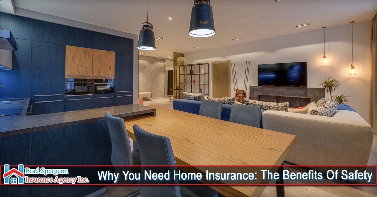 A modern open-plan home featuring a navy kitchen, wooden dining table, and living area