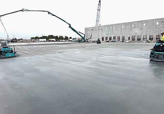A man is riding a machine on a concrete surface.