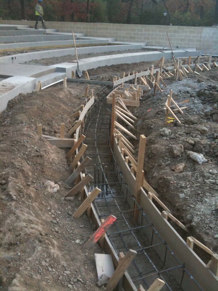A construction site for a headwall with a lot of concrete being poured in Fort Worth