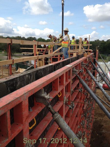 A photo of construction workers building a tilt wall panel