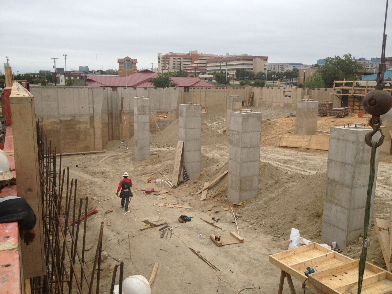 A man in a hard hat walks through a construction site