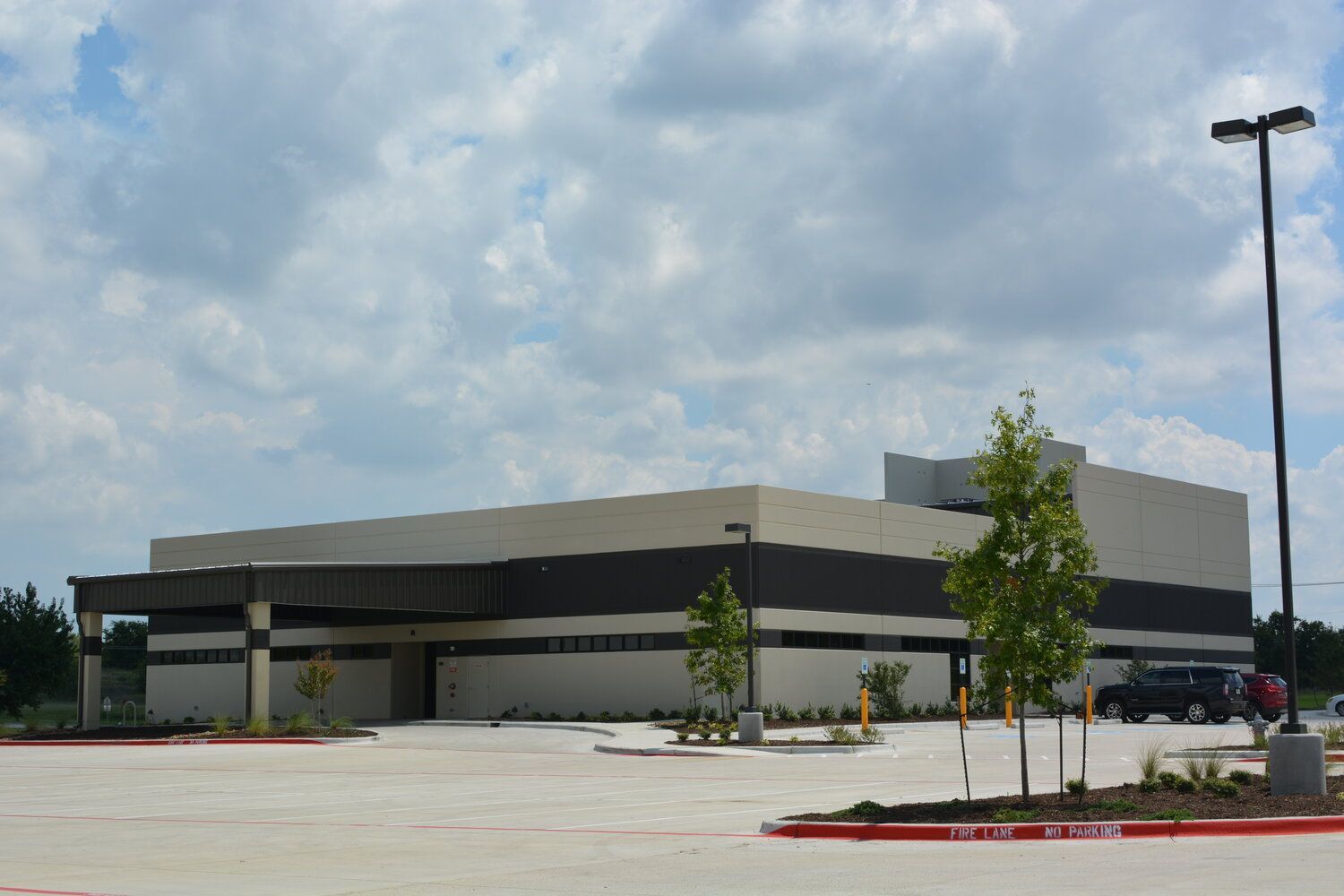 A large building with a parking lot in front of it