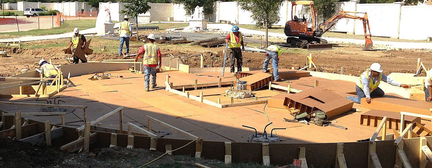 A group of construction workers are working on a concrete construction site.