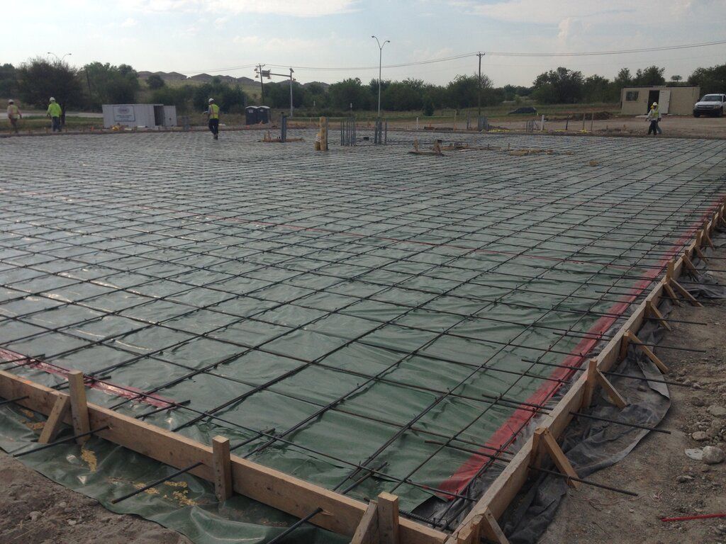 A slab on grade concrete base is being built on a Fort Worth construction site