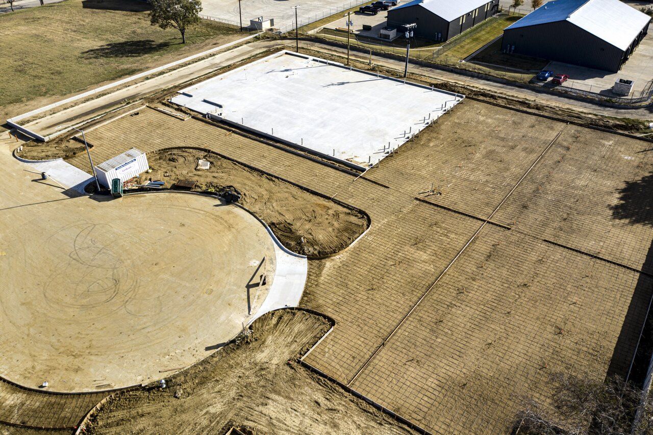 An aerial view of a construction site with a large concrete slab in the middle.