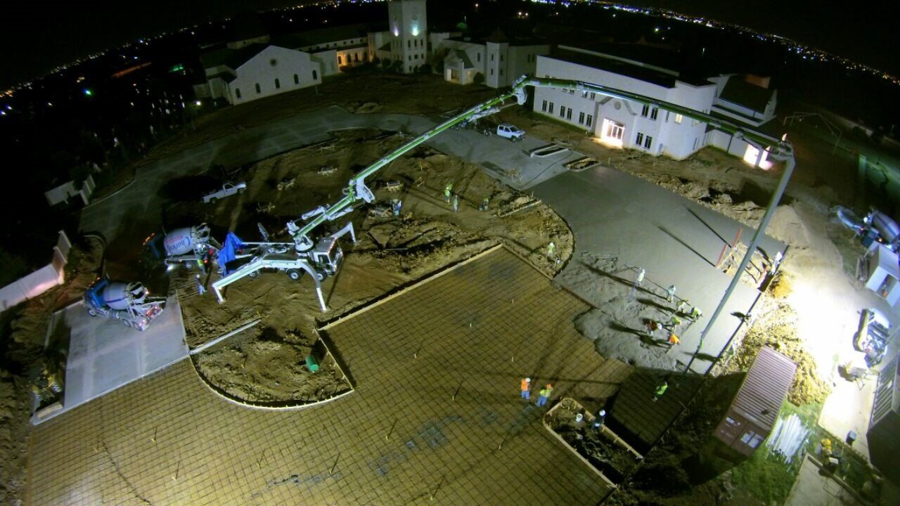 An aerial view of a concrete construction site at night.